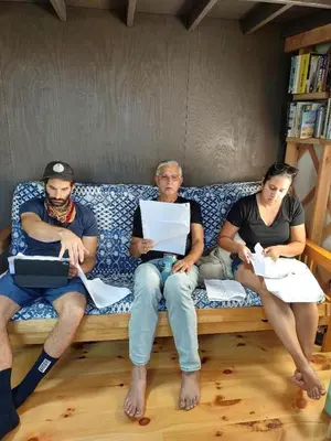 a group of three people sitting on a couch at Beautiful Yurt with Breathtaking Views in Livingston Manor, New York in Livingston Manor