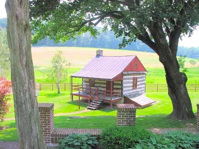 a painting of a play house in a field at Secluded and Rustic Cabin with a Private Deck near Reading, Pennsylvania in Robesonia