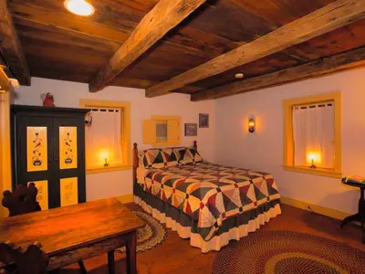 a bedroom with a bed and a wooden ceiling at Secluded and Rustic Cabin with a Private Deck near Reading, Pennsylvania in Robesonia