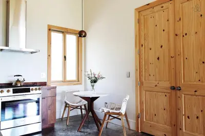 a kitchen with a table and a stove and a window at Luxurious Modern Chalet Rental on Top of the Shawangunk Mountains in New York in Cragsmoor