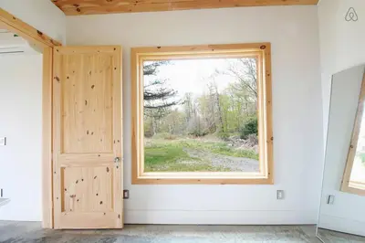 an empty room with a window and a door at Luxurious Modern Chalet Rental on Top of the Shawangunk Mountains in New York in Cragsmoor