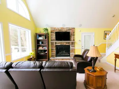 a living room with a couch and a fireplace at Stunning Weekend Getaway near Hickory Run State Park in Pennsylvania in Jim Thorpe