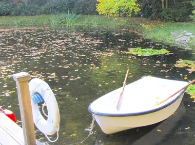 a small boat tied to a dock in the water at Stunning Weekend Getaway near Hickory Run State Park in Pennsylvania in Jim Thorpe