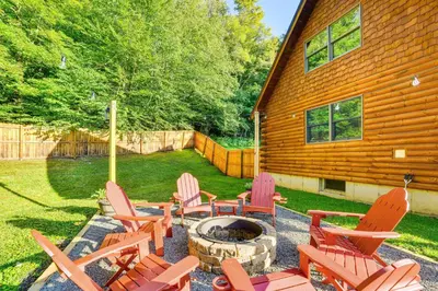 a group of chairs sitting around a fire pit at West Branch Delaware River Cozy Cabin Retreat! in Deposit