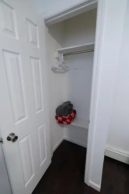 a closet with a white door and a red bag at Hudson Haven-Near NYC Transit in West New York