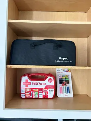 a drawer with a suitcase and a first aid kit at Newly renovated home, firepit, game room, grill in Tobyhanna