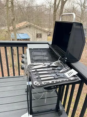 a grill on a deck with a laptop on it at Newly renovated home, firepit, game room, grill in Tobyhanna