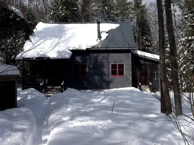 a snow covered house with a pile of snow at Charming Cottage Rental with Antique Decor in Narrowsburg, New York in Narrowsburg