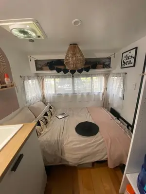 a bedroom with a bed in a tiny house at Vintage Shasta Camper for the best of NYC Glamping in Livingston Manor