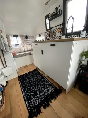 a kitchen with a sink and a rug on the floor at Vintage Shasta Camper for the best of NYC Glamping in Livingston Manor