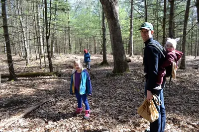 a man and two children walking in the woods at Eco-Friendly, Abstract Treehouse Surrounded by Wildlife and Hiking Trails For a Special Getaway in Sparrow Bush, New York in Sparrow Bush