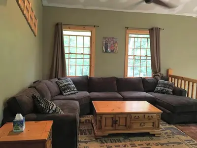 a living room with a couch and a coffee table at Cozy Vacation Rental for 10 with a Fire Pit in Jim Thorpe, Pennsylvania in Jim Thorpe