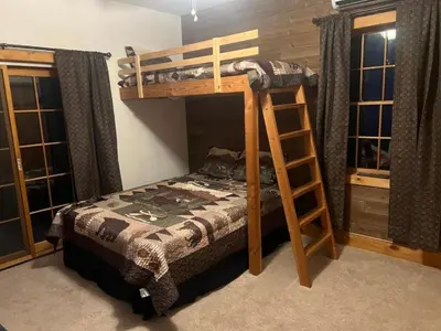 a bedroom with a bunk bed and a ladder at Cozy Vacation Rental for 10 with a Fire Pit in Jim Thorpe, Pennsylvania in Jim Thorpe