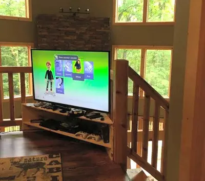 a living room with a large screen tv in a house at Cozy Vacation Rental for 10 with a Fire Pit in Jim Thorpe, Pennsylvania in Jim Thorpe