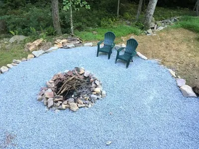 two chairs sitting next to a fire pit at Cozy Vacation Rental for 10 with a Fire Pit in Jim Thorpe, Pennsylvania in Jim Thorpe