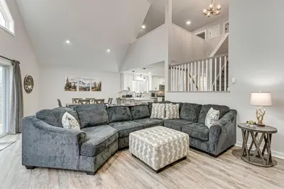 a living room with a couch and a table at Lake and Pool Access Poconos Family Getaway! in Albrightsville