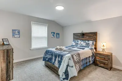 a bedroom with a bed and a window at Lake and Pool Access Poconos Family Getaway! in Albrightsville