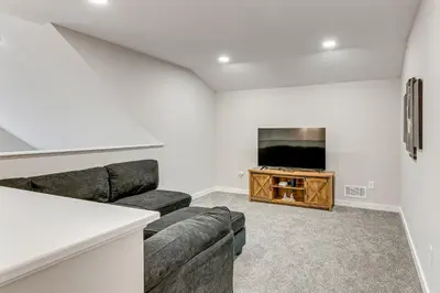 a living room with a couch and a flat screen tv at Lake and Pool Access Poconos Family Getaway! in Albrightsville