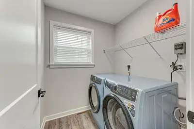 a washing machine in a laundry room with a window at Lake and Pool Access Poconos Family Getaway! in Albrightsville