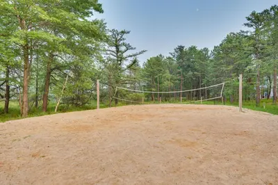 a volleyball net in the middle of a dirt field at Lake and Pool Access Poconos Family Getaway! in Albrightsville