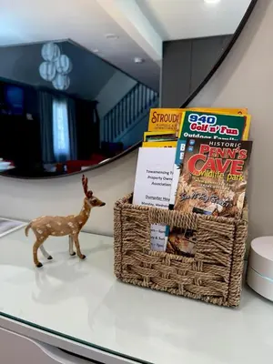 a toy deer sitting on a table with books at Pocono Chalet,Hot Tub,Arcade,Fireplace, Lake,Pool, Pet friendly, near Jim Thorpe No extra fees to use amenities in Towamensing Trails