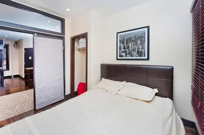 a bedroom with a large bed and a large window at The Ideal II Vibe 8558 in New York