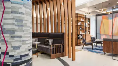 a lobby with a couch and a table and chairs at The Vibe on 5th IV Vibe 8753 in New York
