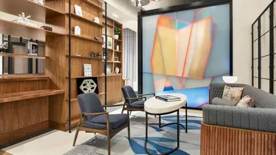 a living room with a couch and chairs and a tv at The Vibe on 5th XIII Vibe 8762 in New York