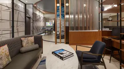 a living room with a couch and a table and chairs at The Vibe on 5th XIII Vibe 8762 in New York