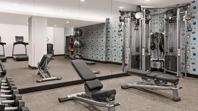 a gym with several tread machines and mirrors at The Vibe on 5th XIII Vibe 8762 in New York