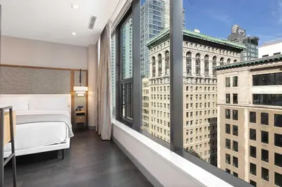 a bedroom with a bed and a view of a city at The Vibe on 5th XIII Vibe 8762 in New York