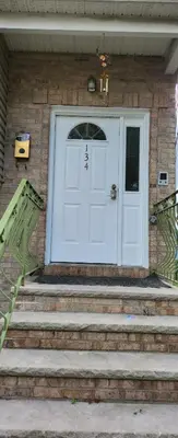 a white door on a brick house with stairs at Happiness queen room 3 in Newark