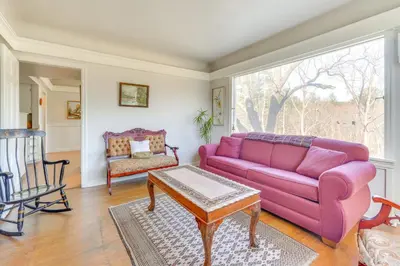 a living room with a purple couch and a table at Historic Manor 3 Mi to Shawnee Mtn! Pet Friendly in East Stroudsburg