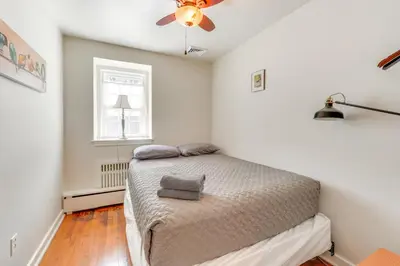 a bedroom with a bed and a ceiling fan at Historic Manor 3 Mi to Shawnee Mtn! Pet Friendly in East Stroudsburg