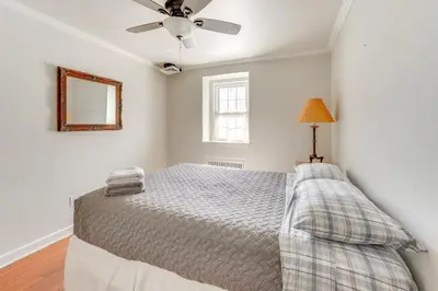a bedroom with a bed and a ceiling fan at Historic Manor 3 Mi to Shawnee Mtn! Pet Friendly in East Stroudsburg