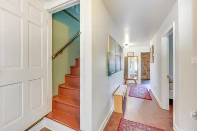 a hallway with a door and stairs with rugs at Historic Manor 3 Mi to Shawnee Mtn! Pet Friendly in East Stroudsburg