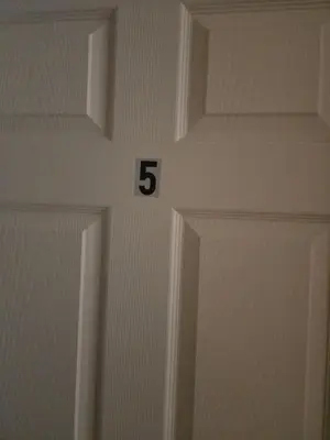 a white door with the number on it at Honey queen room 5 in Newark