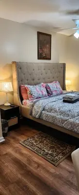 a bedroom with a large bed with a large headboard at Beautiful Room king in Newark