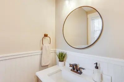 a bathroom with a sink and a mirror at Family-Friendly Townhome with Patio in Columbia! in Columbia