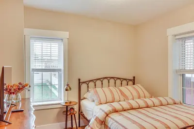 a bedroom with a bed and two windows at Family-Friendly Townhome with Patio in Columbia! in Columbia