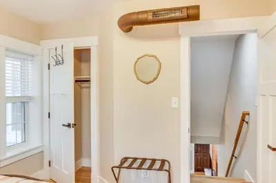 a hallway with a door and a mirror on the wall at Family-Friendly Townhome with Patio in Columbia! in Columbia