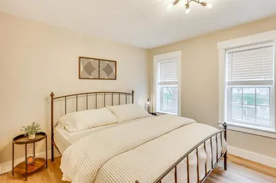 a bedroom with a bed and two windows at Family-Friendly Townhome with Patio in Columbia! in Columbia