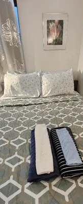 a bedroom with a bed with two towels on it at Amazing family house in Newark