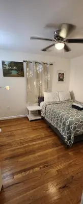 a bedroom with a bed and a ceiling fan at Amazing family house in Newark