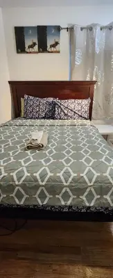 a bedroom with a bed with a wooden head board at Amazing family house in Newark
