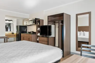a hotel room with a bed and a television at SureStay Studio by Best Western Paradise Lancaster County in Paradise