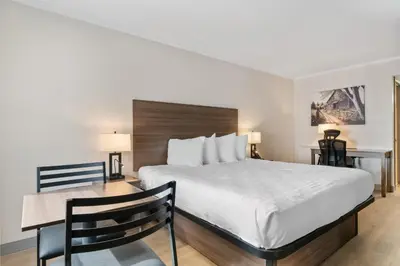 a hotel room with a bed and a desk at SureStay Studio by Best Western Paradise Lancaster County in Paradise