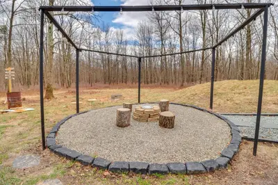 a swing set with two logs and a table at 9 Mi to Big Boulder Mtn A-Frame Cabin with Hot Tub in Albrightsville
