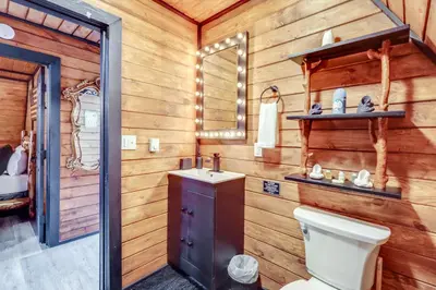 a bathroom with a toilet and a sink at 9 Mi to Big Boulder Mtn A-Frame Cabin with Hot Tub in Albrightsville