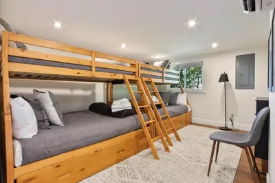 a bedroom with two bunk beds and a couch at Home at Camelback Mtn with Game Room near Waterparks in Tannersville